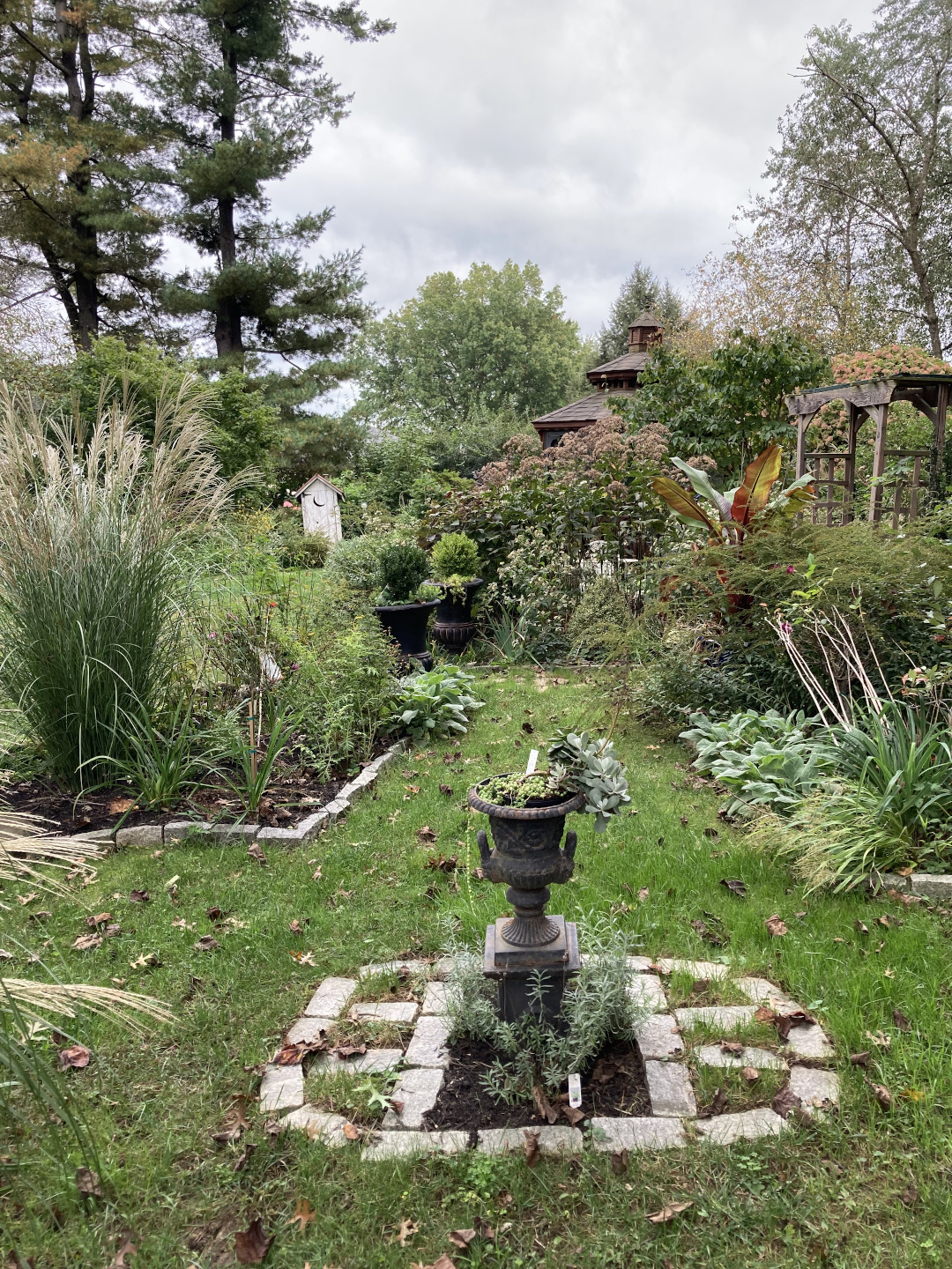 tall grasses and other perennials largely screen out views of the rest of the garden, only hinting at the rest of the garden to explore