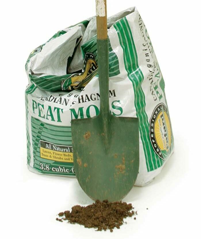 shovel with open bag of peat moss