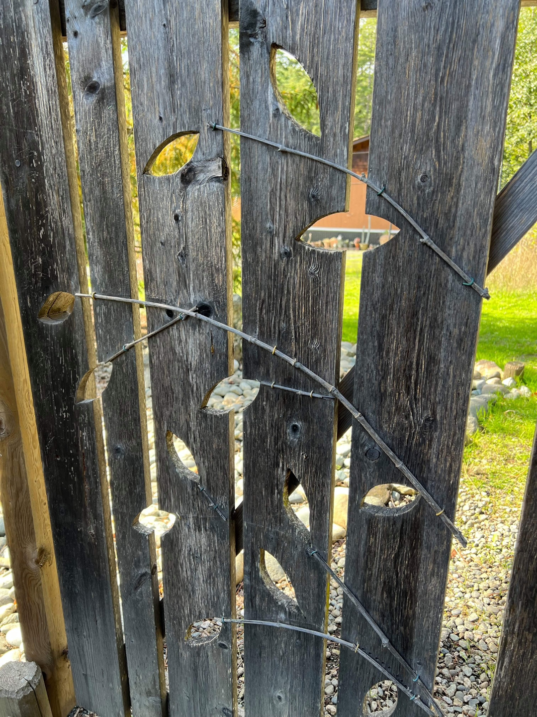 branch and leaf design on a wooden gate