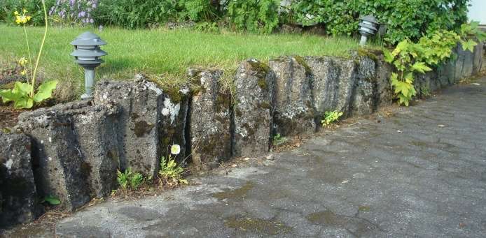 solid wall of rock with two lights on top