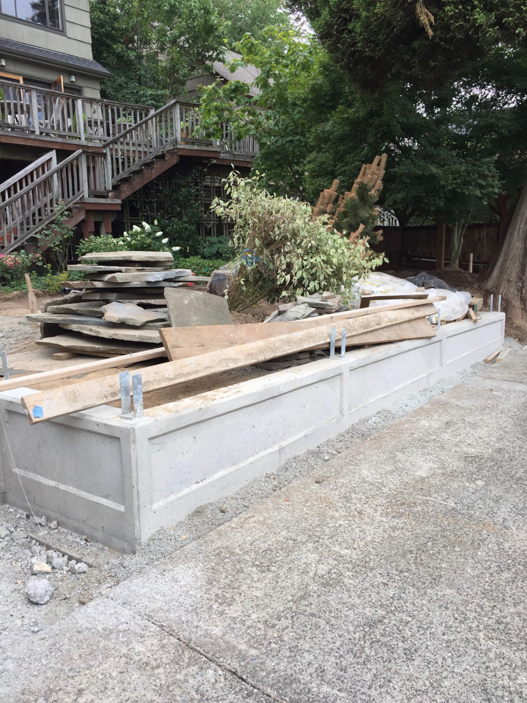 a concrete retaining wall was designed to hold back the soil at the property line