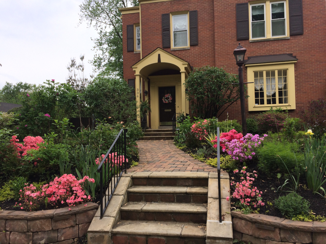 front yard garden with shrubs and pink flowers