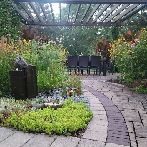 garden beds around stone path leading to patio