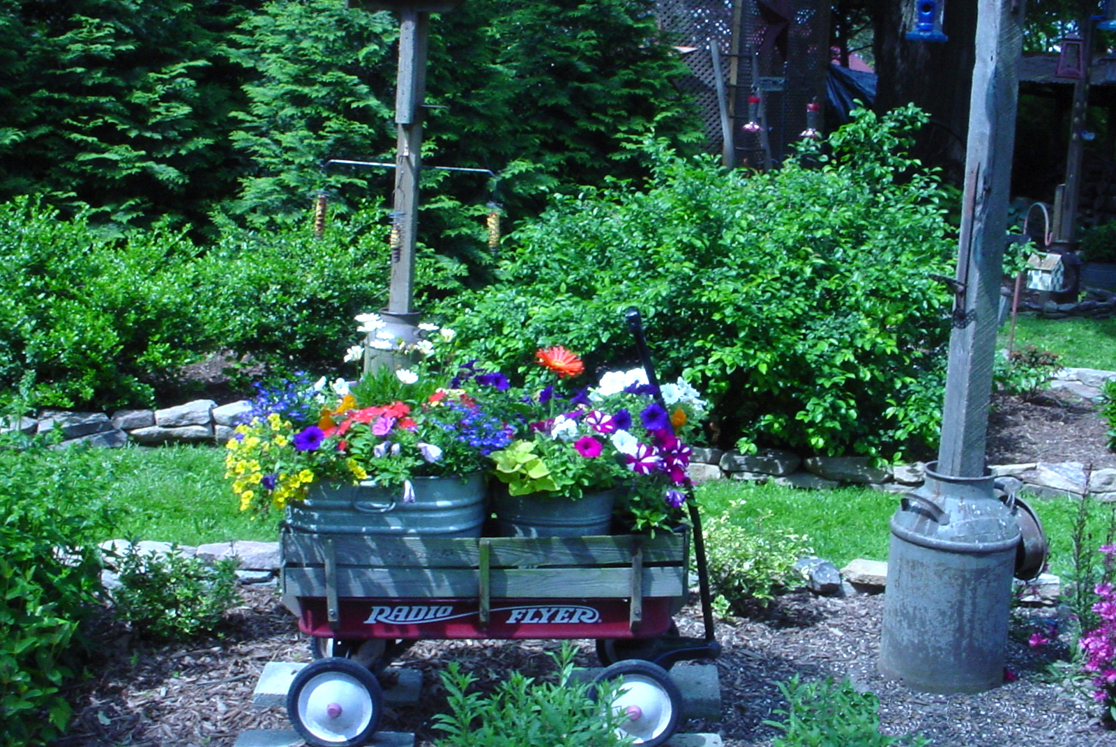 old wagon full of colorful container plantings