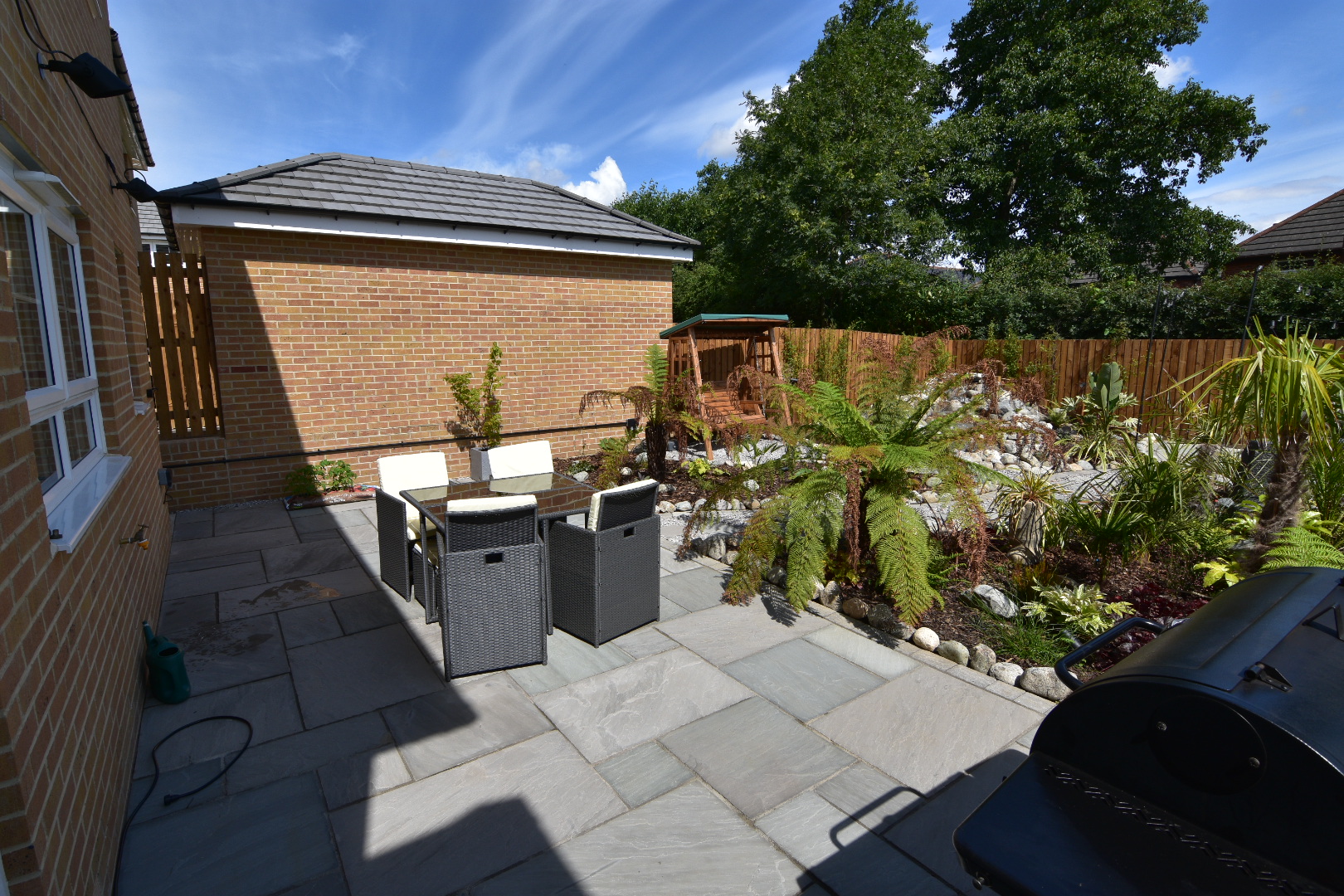 small patio garden with lots of tropical plants