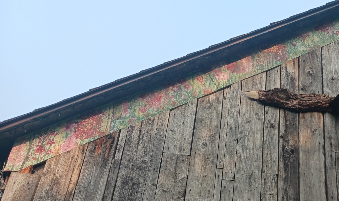 fascia board on the back of the garage painted with various flowers of all colors