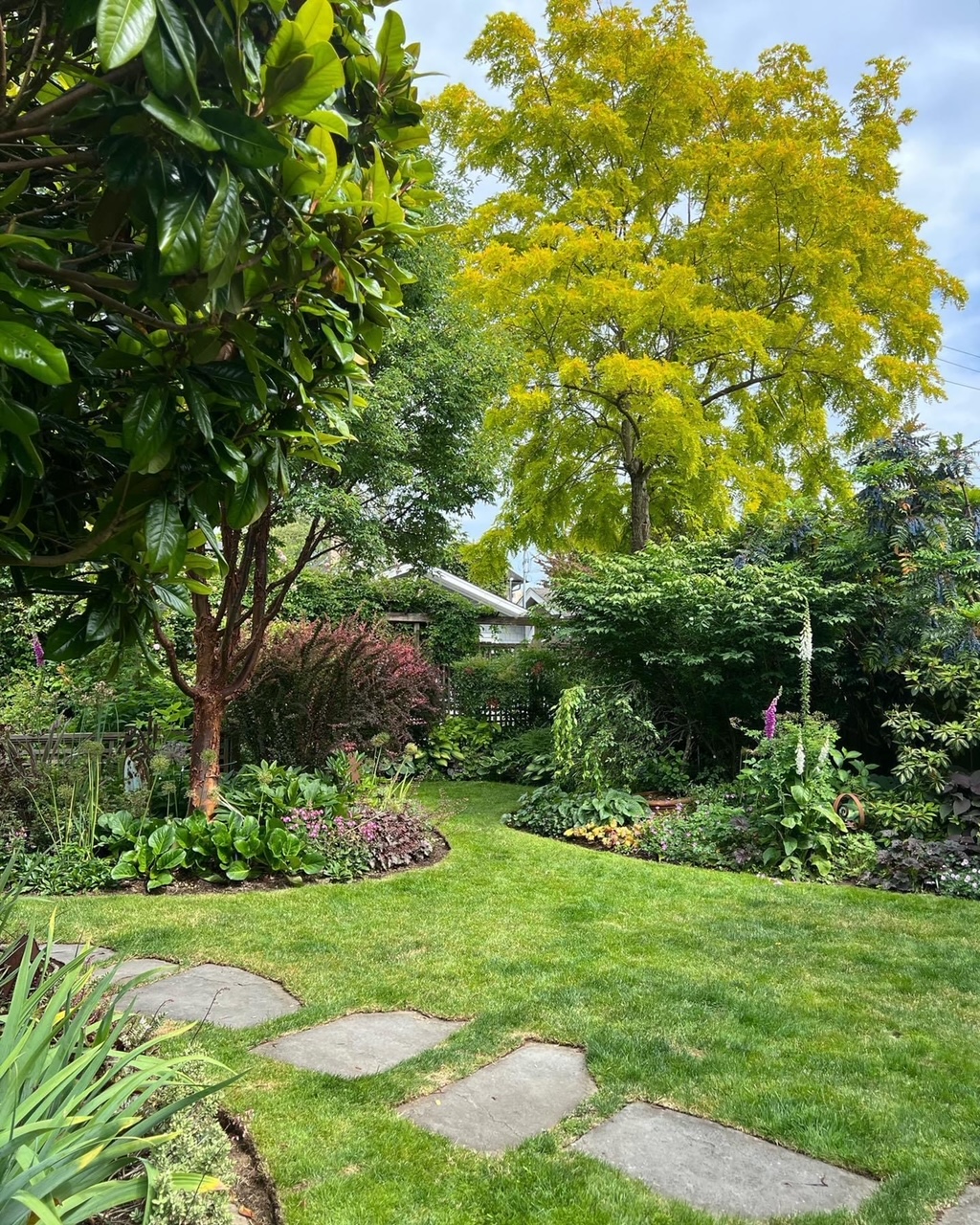 lawn with stepping stone path and perfectly edged garden beds