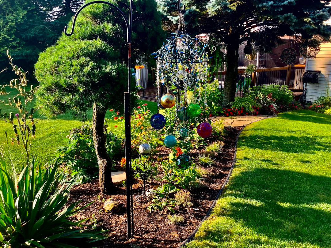 colorful wind chime in a garden bed