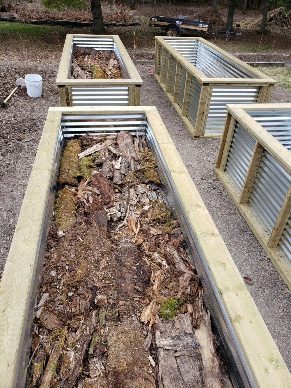 new raised garden beds filled with decaying wood material