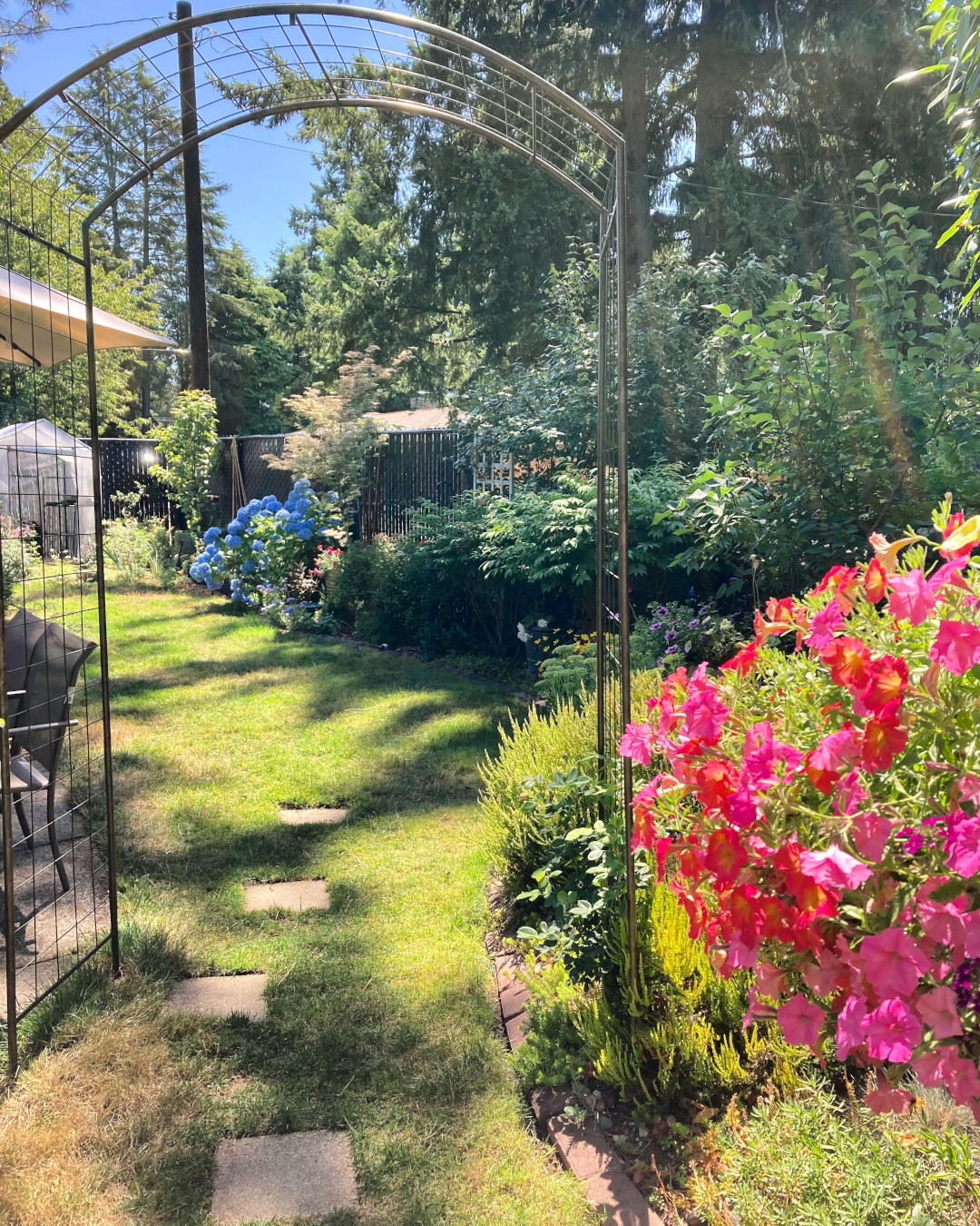 view of back garden through arbor