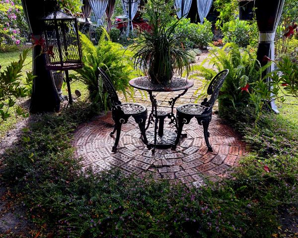 small brick circle patio with plants surrounding