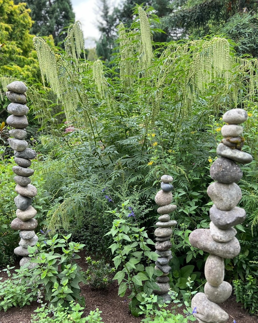 three stacked stone sculptures in the garden