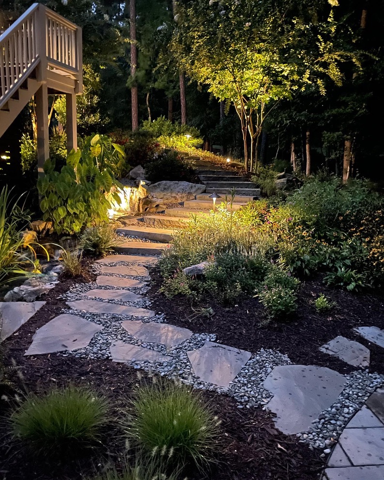 stone step garden pathway illuminated at night