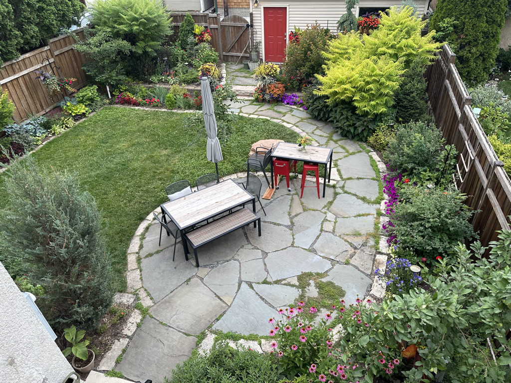 view of small garden and patio from above