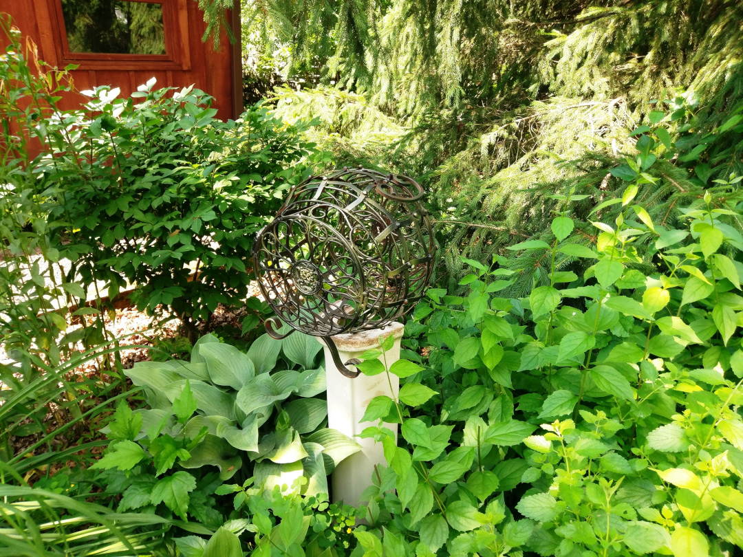 unique garden art surrounded by green foliage