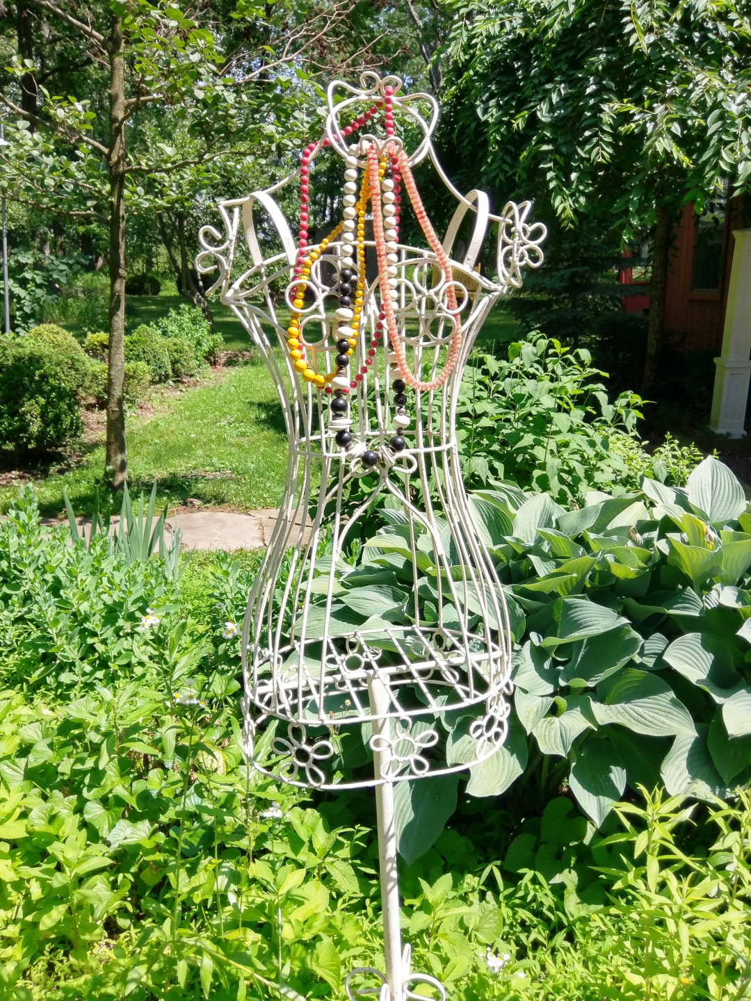 white metal body form in the garden