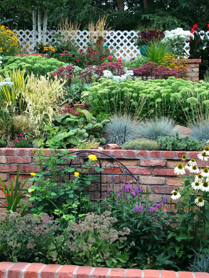 close up of tiered garden bed with brick walls