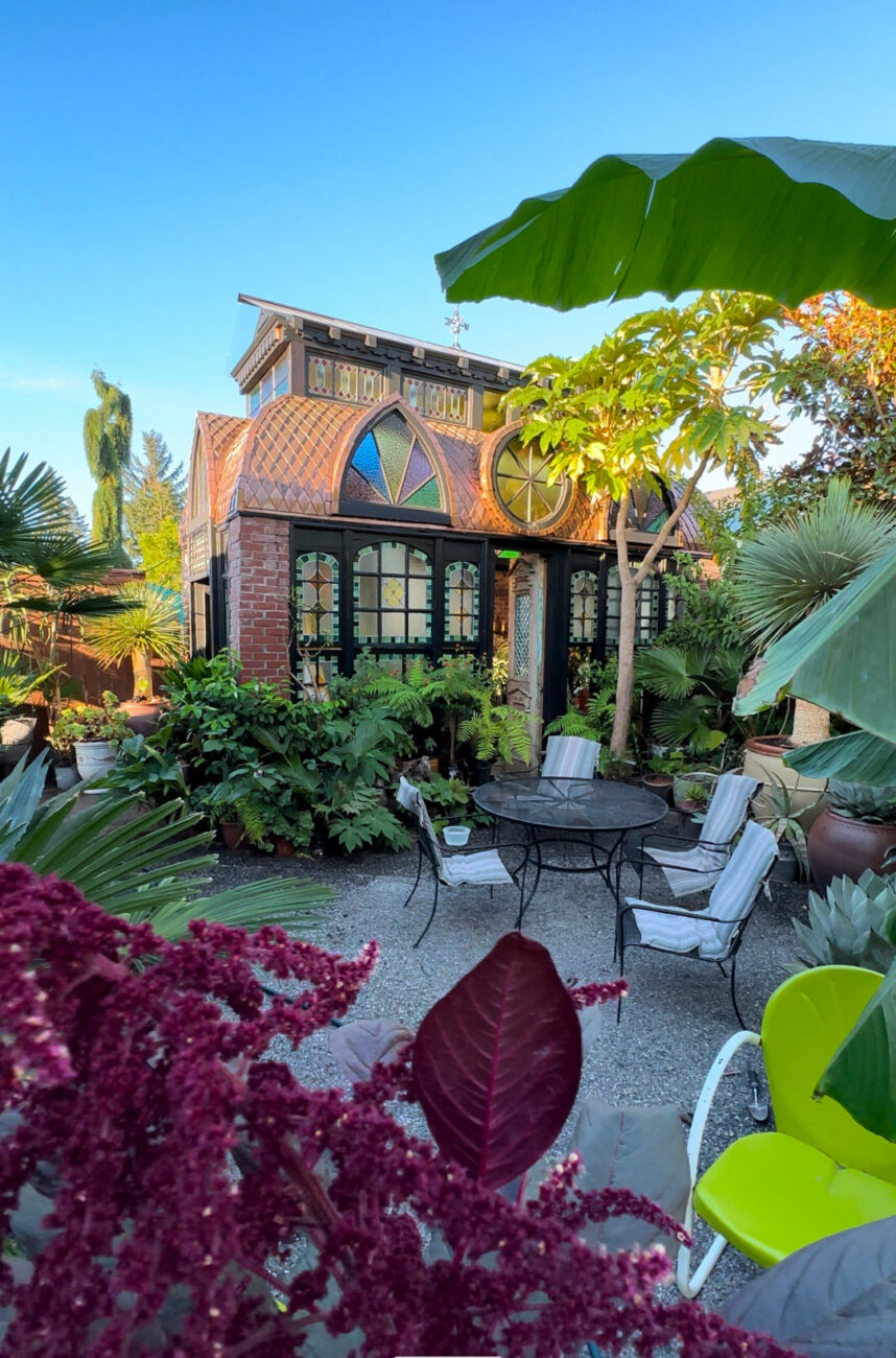 stained glass conservatory with small gravel garden patio outside