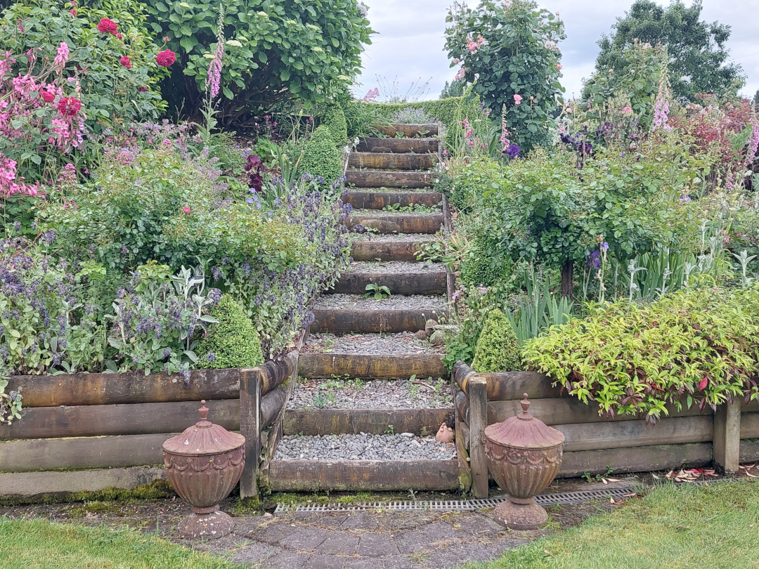 stairs between two garden beds on a slope