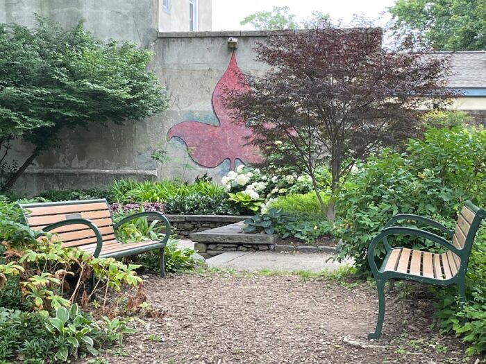 two benches in a community park garden