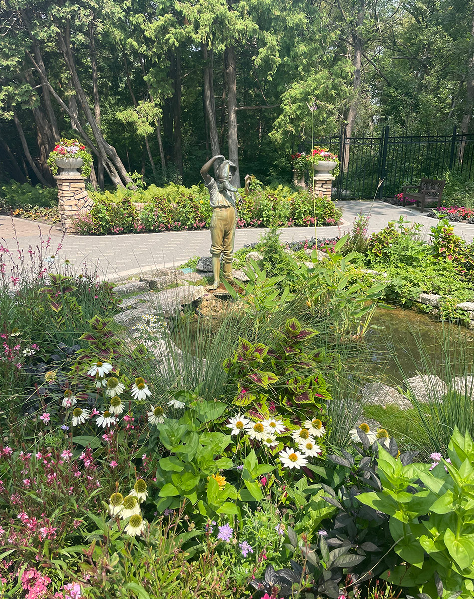 garden fountain surrounded by plants