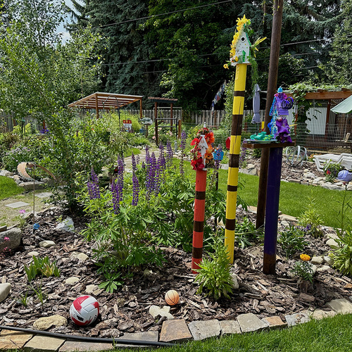 colorful birdhouses on poles