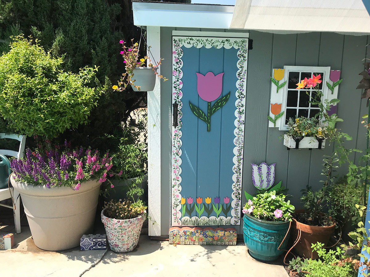 summer containers around pool shed