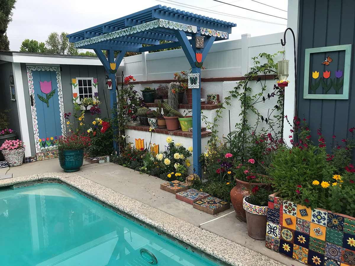 pool shed next to pergola and garden