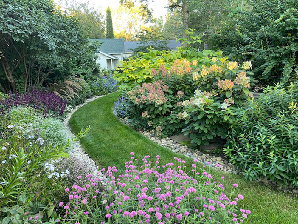 late summer garden with a grass garden path cutting through