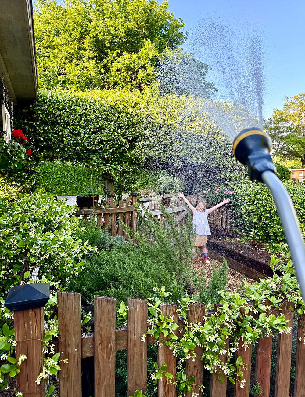 having fun in garden with water hose