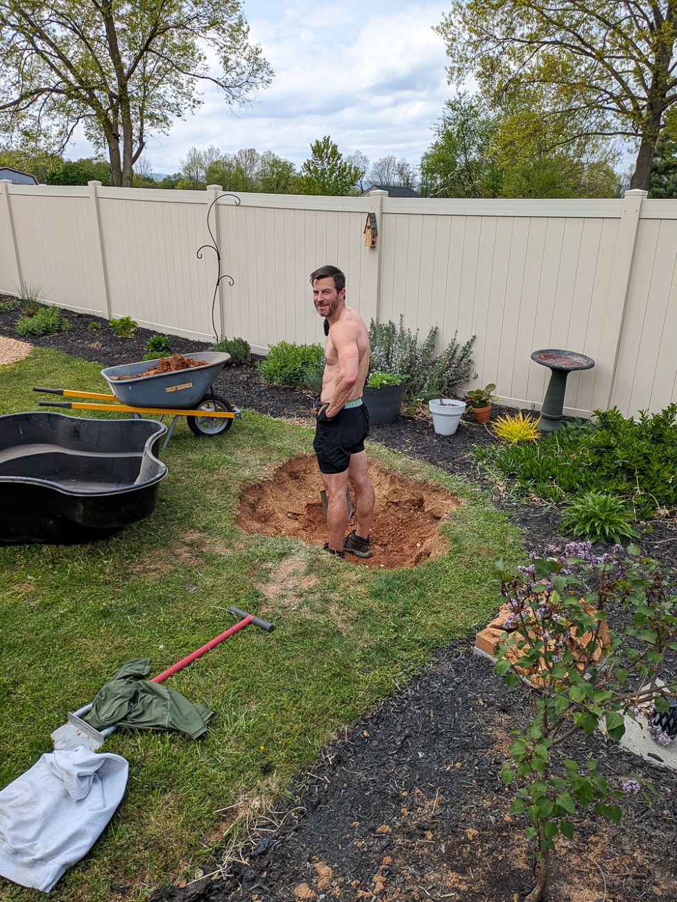 Digging the first backyard garden pond beside perennial beds