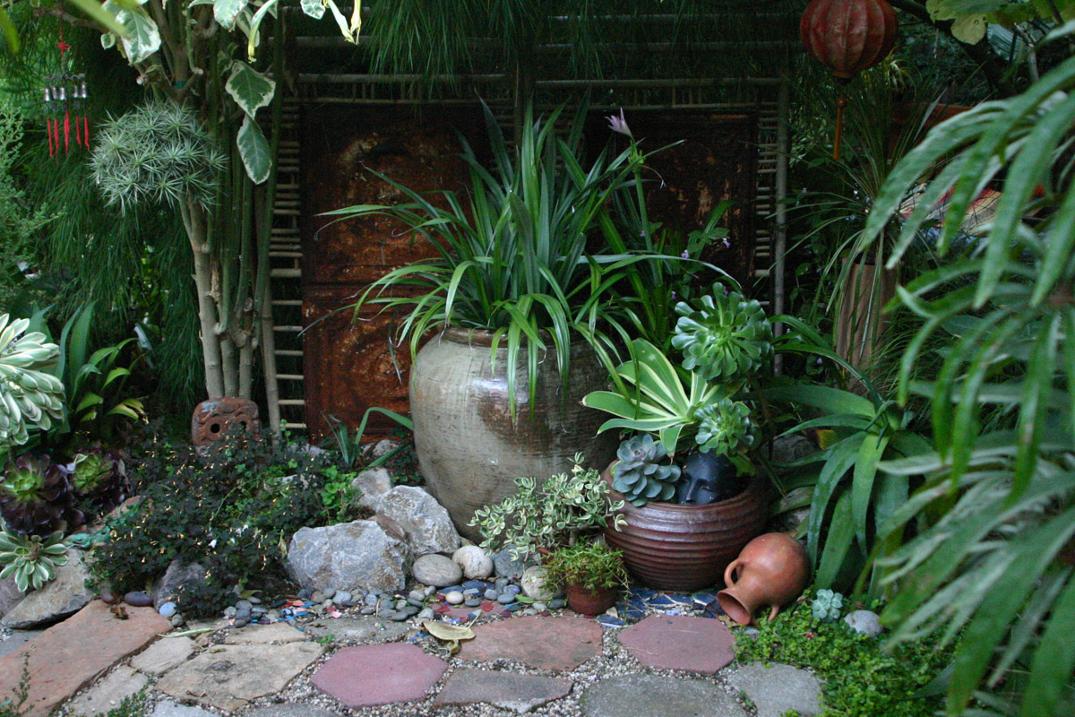 Oakland California garden, earthenware pots, metal garden panel, textural foliage, garden vignette, garden art