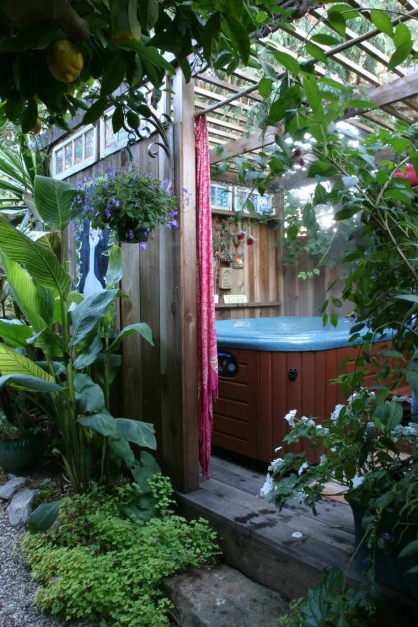 secluded garden hideaway, covered hot tub structure, lush tropical foliage, climbing vines, garden art, Oakland California garden