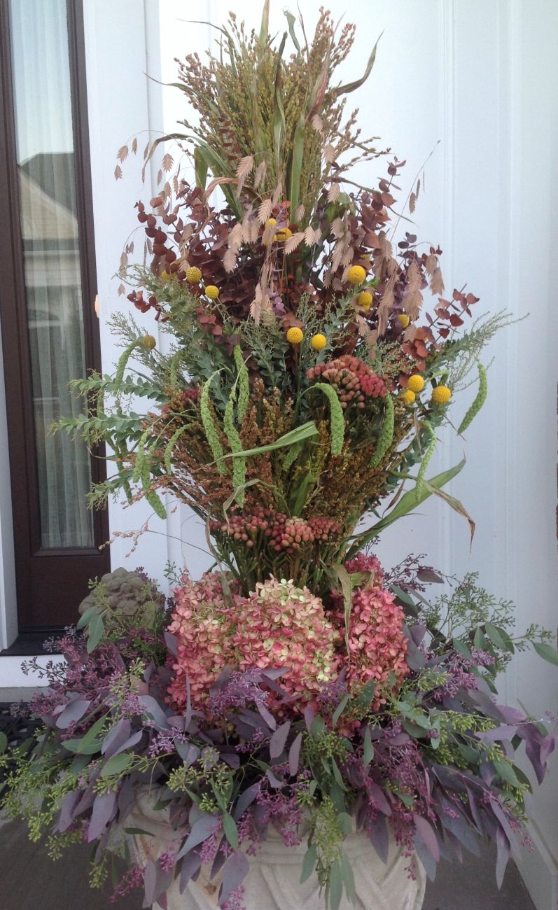 Tall autumn urn arrangement, northern sea oats, dried eucalyptus, yellow drumstick flowers, panicle hydrangeas, broom corn