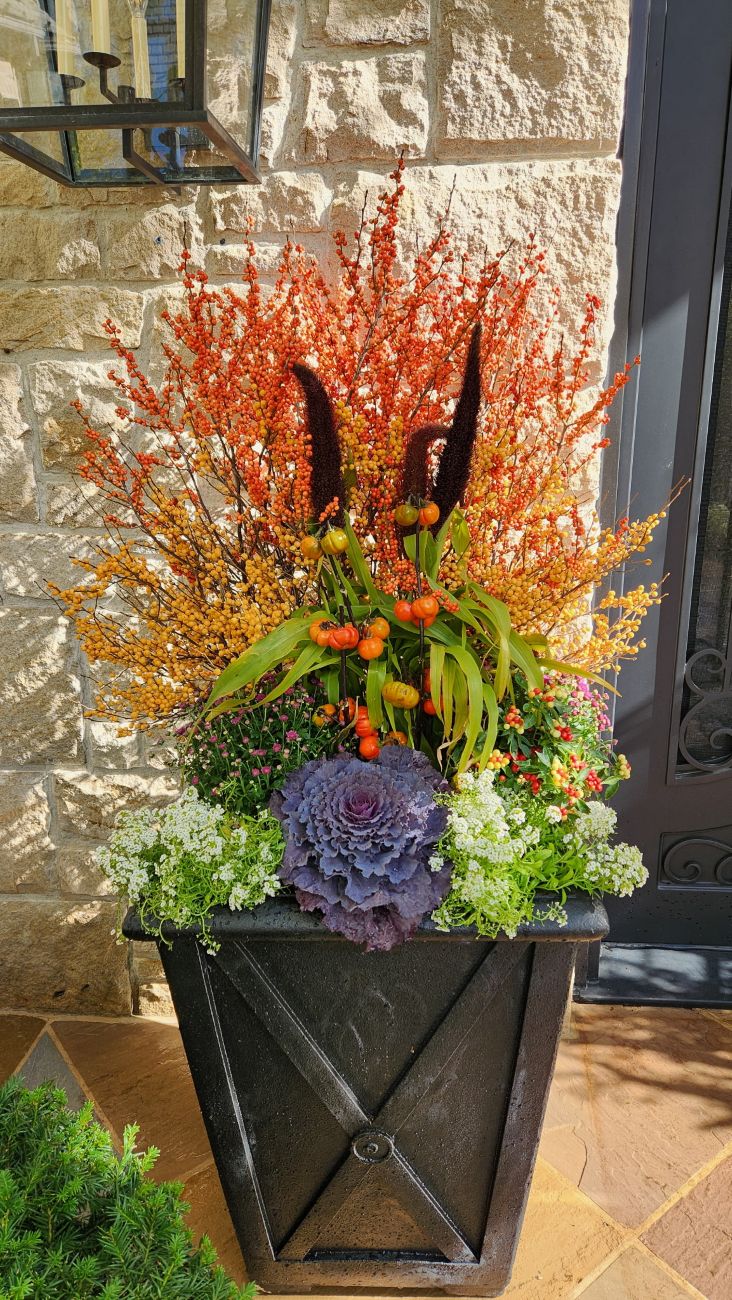 Autumn side-entry container, orange and yellow winterberries, chartreuse millet, pumpkins-on-a-stick, ornamental peppers, white alyssum