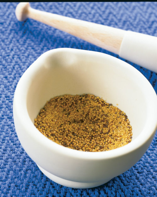 mustard seed ground by a mortar and pestle